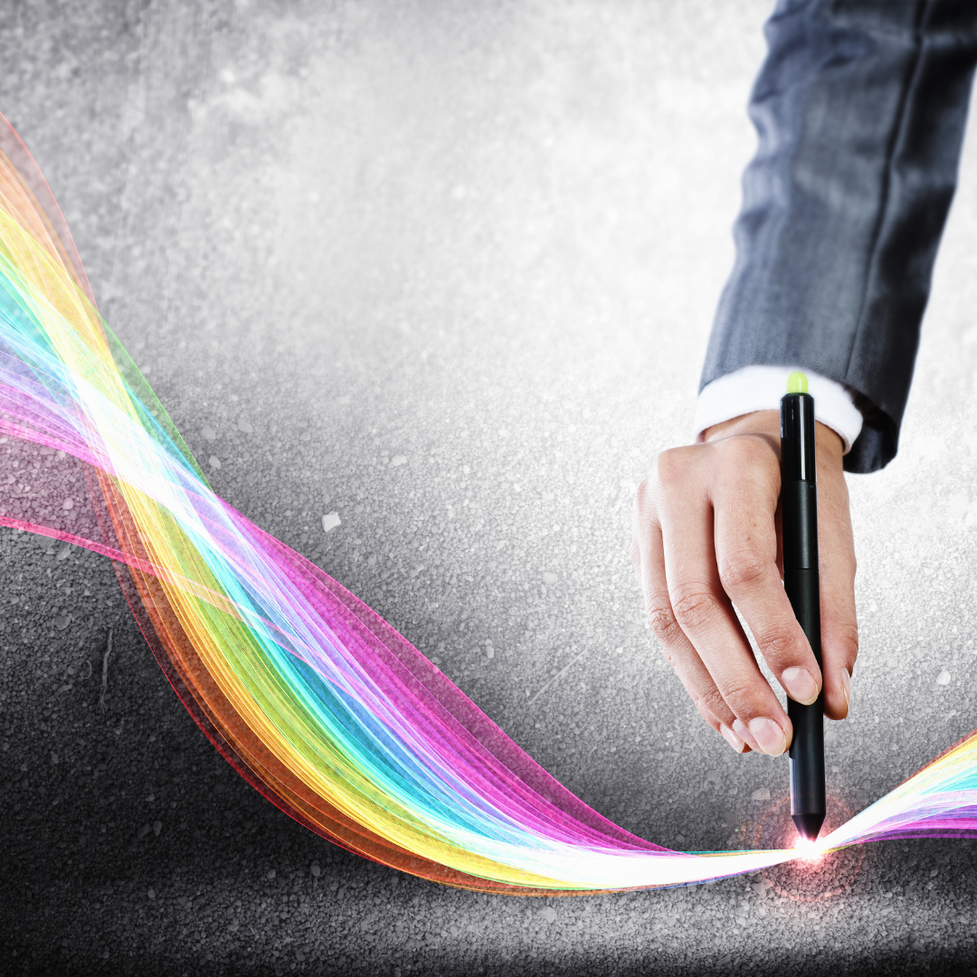 Hand holding a pen touching VIBGYOR colours