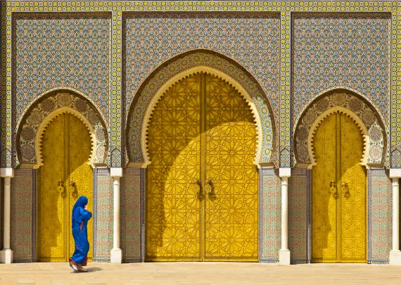 Lady walking in front of a luxury door in Morocco